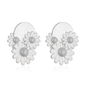 Detailed close-up of triple white daisy earrings with silver metal flower core details