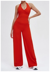 Two-piece red yoga set featuring a V-neck halter top and high-waist wide-leg pants
