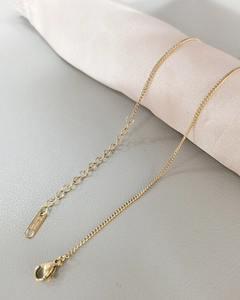 Detail of gold stainless steel necklace with lobster clasp and S.STEEL engraved tag