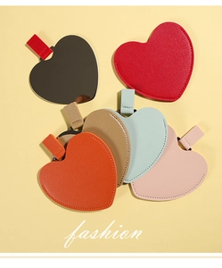 Detail view of colorful heart-shaped mirrors with PU leather texture and straps