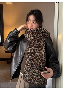 Detailed view of leopard print faux wool scarf paired with a brown leather bomber jacket