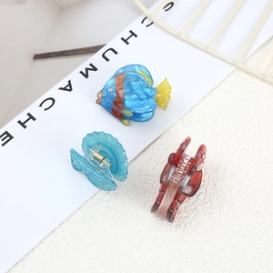 Ocean-themed acetate hair clips featuring tropical fish and seashell designs