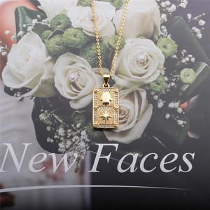 Detail of a golden Hamsa Hand and star pendant with sparkling cubic zirconia inlay