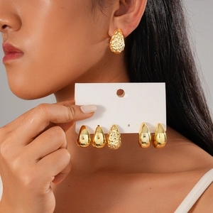 Six-piece set of golden teardrop earrings with smooth and hammered metal textures