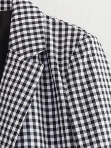 Detail of lapel and shoulder tailoring on a black and white gingham checkered blazer