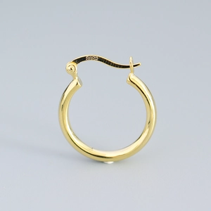 Polished golden 925 sterling silver hoop earring with S925 hallmark on a gray background