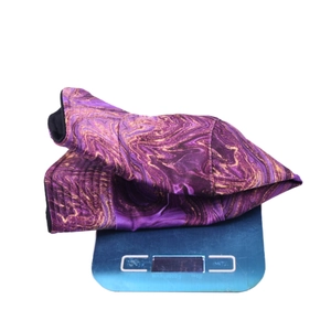 Lightweight marble print bucket hat weighing approximately 61g on a digital scale