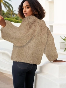 Detailed close-up of brown faux fur jacket texture with fluffy plush material and soft fibers