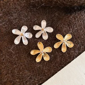 Orecchini a fiore in metallo spazzolato nelle finiture oro e argento liscio