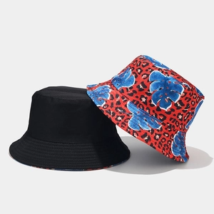 Dettaglio del cappello da sole reversibile con stampa leopardata e foglie tropicali blu