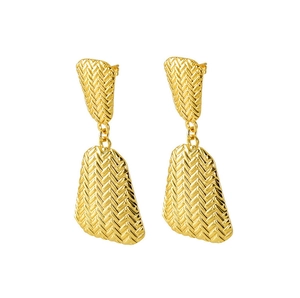 Macro view of gold-plated geometric earrings with intricate woven herringbone texture