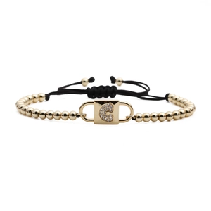 Adjustable black rope bracelet with gold metal beads and zircon inlaid C-lock charm