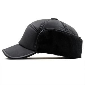 Detail view of winter flat cap with faux fur earflaps and leather texture for men