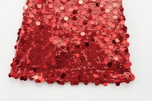 Close-up of vibrant red sequins and shimmering metallic finish on the mini A-line skirt