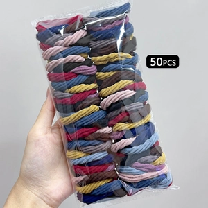 Detailed view of 50 elastic seamless hair ties in assorted earthy tones and colors