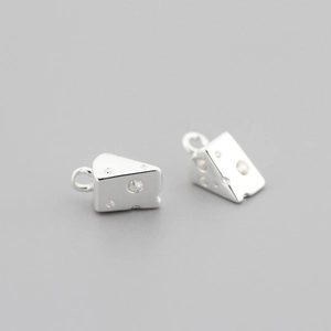 Detailed view of silver cheese-shaped pendants with small clear crystals for DIY jewelry