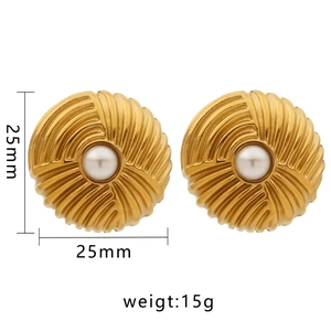 Detail of 25mm irregular golden textured earrings with center pearl on white background
