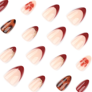 Red French almond press-on nails with amber tortoiseshell and gold chain floral design