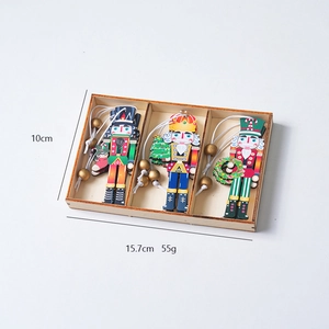 Three-piece wooden nutcracker ornament set in a gift box with red and blue paint