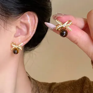 18K gold plated bow earrings with sparkling zircon and spherical tiger eye stone drop