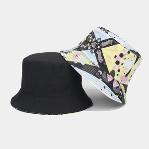 Detail view of double-sided bucket hat in solid black and colorful 3D geometric print