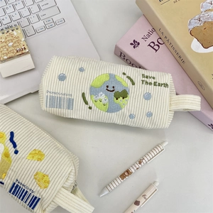 Detailansicht eines süßen Cord-Federmäppchens mit Stickerei auf einem Schreibtisch