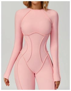 Detail of pink long-sleeve yoga bodysuit featuring contoured seams and ribbed fabric