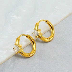 Close-up of gold-plated hoop earrings with star-shaped zircon inlays for a vintage look