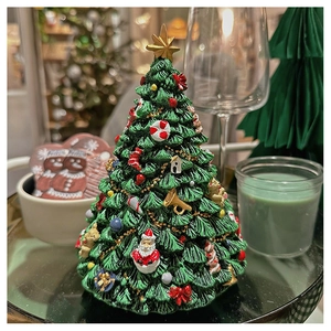 Close-up of a rotating Christmas tree music box with detailed festive ornaments and resin texture