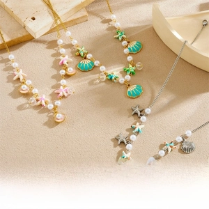 Detailed view of ocean theme necklaces with shell, starfish pendants and pearls