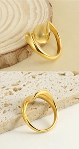 Detail of 18k gold plated stainless steel ring with irregular wavy design on stone base