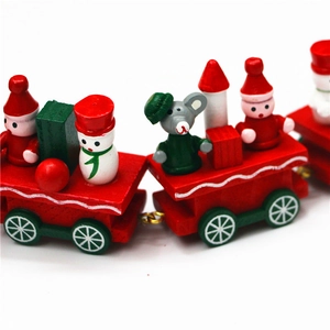 Close-up of a festive wooden Christmas train toy with Santa, snowman, and gift box details