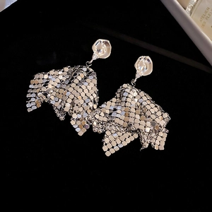 Detail of silver geometric fringe earrings with shiny sequin mesh and crystal stud