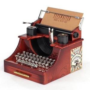Vintage typewriter music box model with wood grain finish and pull-out drawer details