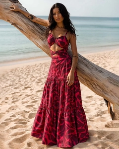 Detail of red abstract print beach dress featuring cutout waist and layered tiered skirt