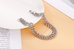 Detail of a four-layer silver stainless steel cable chain bracelet with lobster clasp