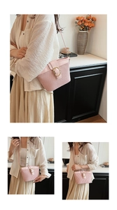 Detailed close-up of pink woven crossbody bucket bag with golden circular metal buckle