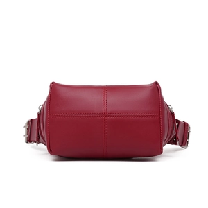 Detail view of red PU leather bag showing cross-stitch patterns and metal buckle hardware