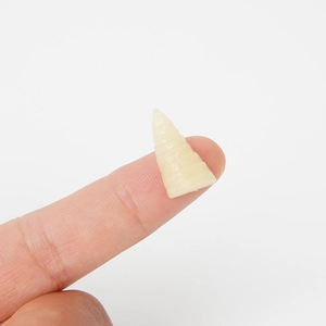 Miniature PVC bamboo shoot replica for DIY crafts shown on a fingertip on white background