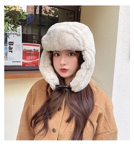 Detail of plush cream aviator hat with soft faux fur and adjustable buckle chin strap