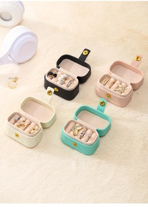 Macro shot of colorful mini jewelry boxes in multiple partitions on soft velvet