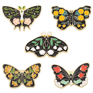Five vintage butterfly enamel pins set with colorful floral patterns on a white background
