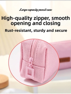 Macro shot of smooth zipper and light pink linen fabric on a large capacity pencil case