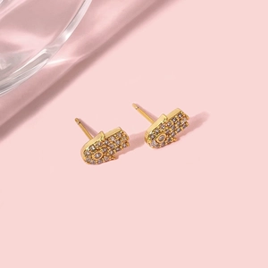 Detailed close-up of gold-plated Hamsa hand stud earrings with sparkling white zircons