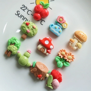 Detailed close-up of resin cartoon flower, mushroom and tree charms for DIY crafts