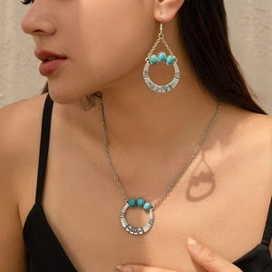 Boho turquoise coconut tree jewelry set with earrings and pendant necklace on model