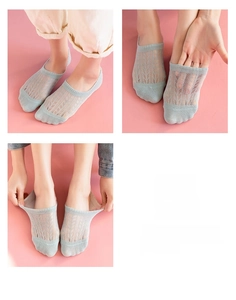 Detail view of light blue mesh lace socks with breathable leaf-pattern hollow knit