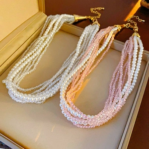 Detail of bohemian multilayer pearl and crystal necklaces in a jewelry box
