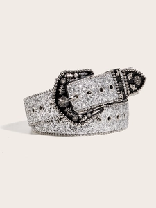 Detail of silver western belt featuring ornate metal buckle and sparkling rhinestone studs