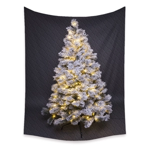 Detailed view of flocked Christmas tree branches with warm white LED lights and metal stand